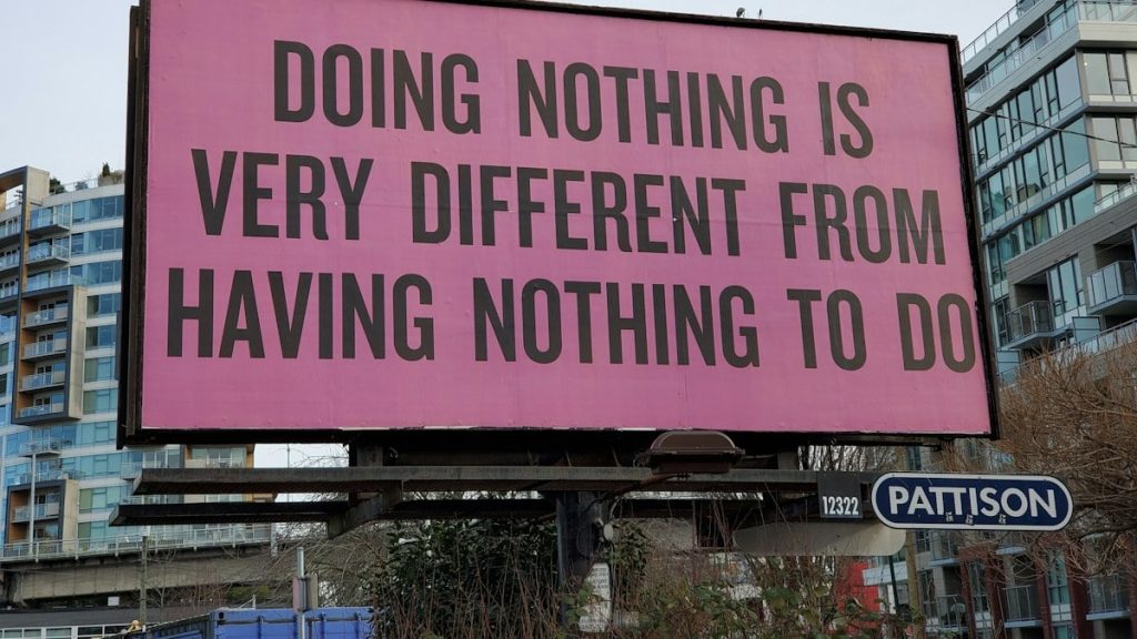 a large pink billboard with a quote on it